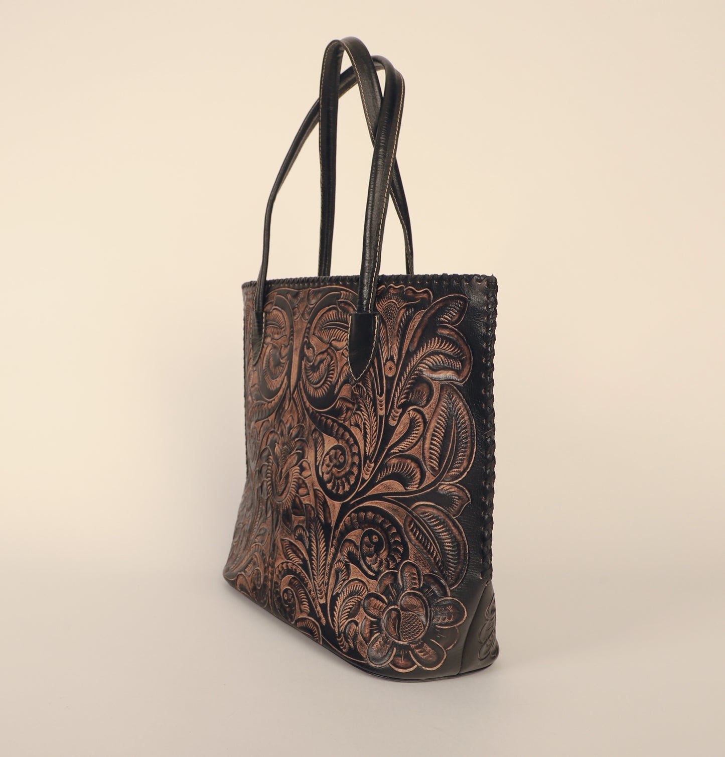 Over-sized authentic leather tote bag with traditional Mexican design etched on both sides. Fully lined with suede. Side view