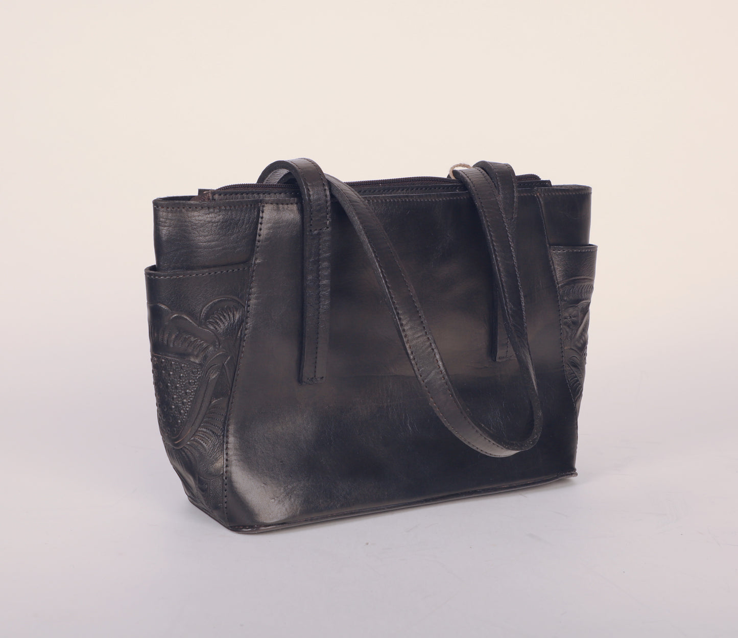 Medium-sized full leather tote bag with traditional Mexican design on side pockets. Fully lined with suede.  Color black.