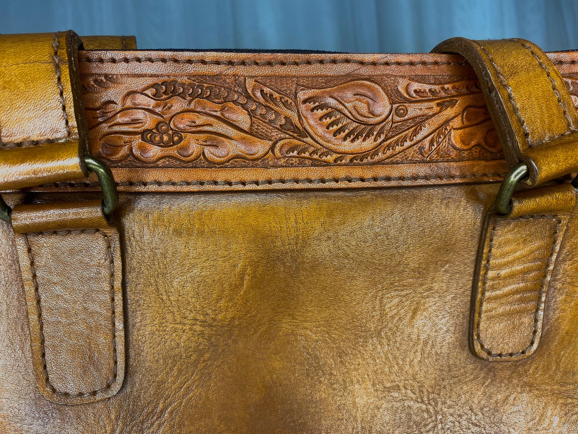 Medium-sized full leather messenger bag with one inch of traditional mexican Etching on the upper portion of the bag. Fully lined with suede.  Camel Mexican etching  detail.