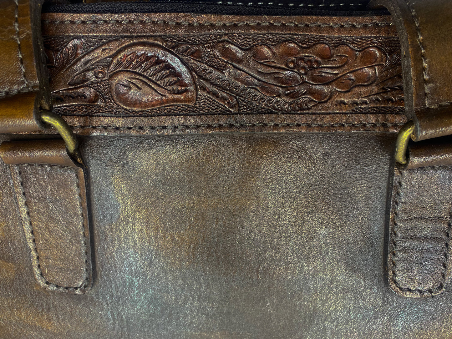 Medium-sized full leather messenger bag with one inch of traditional mexican Etching on the upper portion of the bag. Fully lined with suede.  Brown Mexican etching  detail.