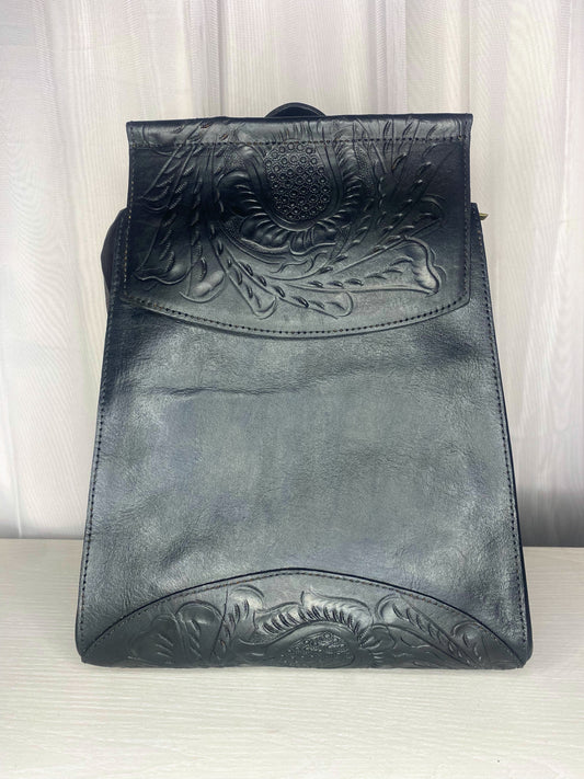 medim sized authentic leather backpack. Trapezoid shaped with flap with Mexican design on the flap. Straps can be converted to crossbody or used as dual straps. Front view in color black. 